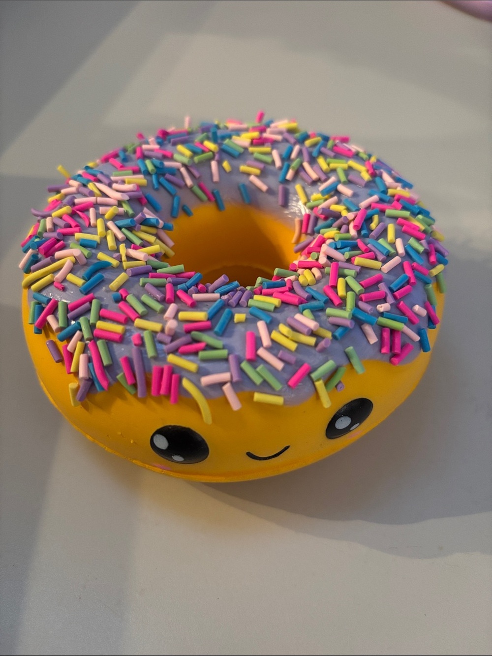 Smiling Yellow Donut Plush Toy with Purple Frosting and Rainbow Sprinkles
